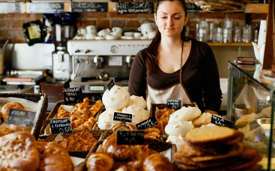 A bakery owner behind a counter of fresh pastries